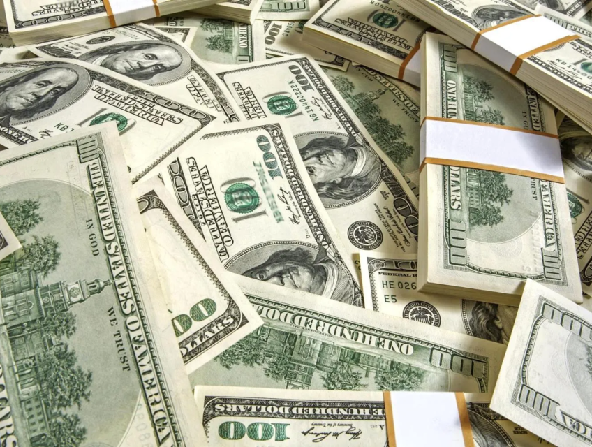 Stacks of U.S. 100-dollar bills illustrating the currency's strength amid global market changes.