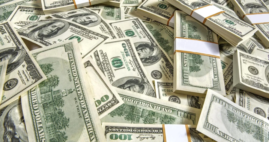 Stacks of U.S. 100-dollar bills illustrating the currency's strength amid global market changes.