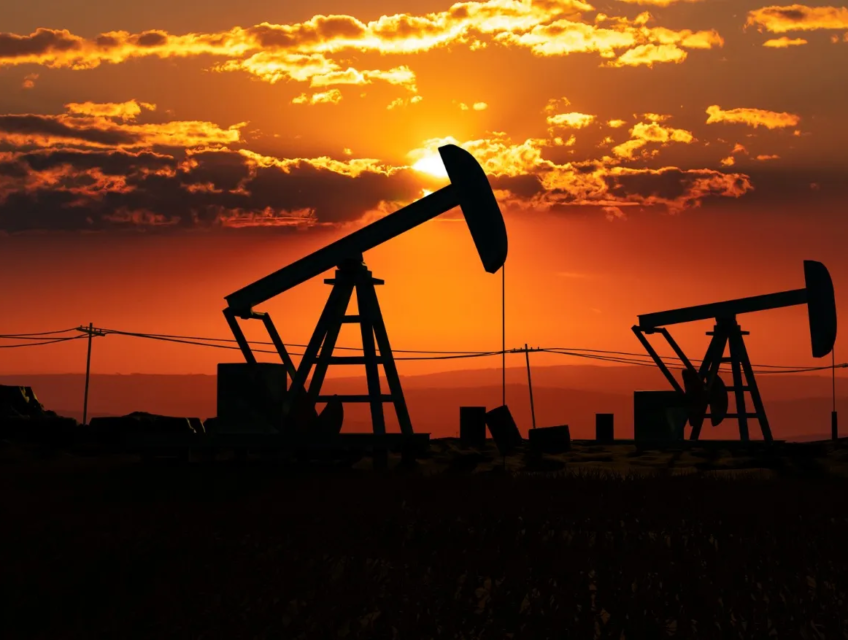 Silhouetted U.S. oil pump jacks at sunset, highlighting energy production and the fuel industry's landscape