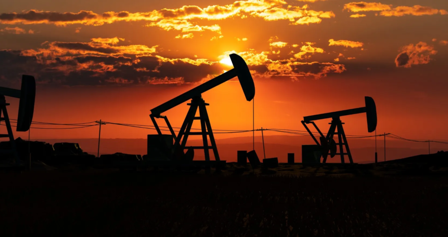 Silhouetted U.S. oil pump jacks at sunset, highlighting energy production and the fuel industry's landscape