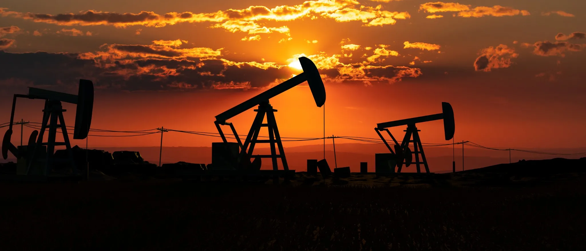 Silhouetted U.S. oil pump jacks at sunset, highlighting energy production and the fuel industry's landscape