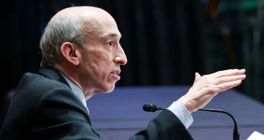 Gary Gensler, the SEC chairman, speaking at a public event, gesturing with his hand while seated in front of a microphone