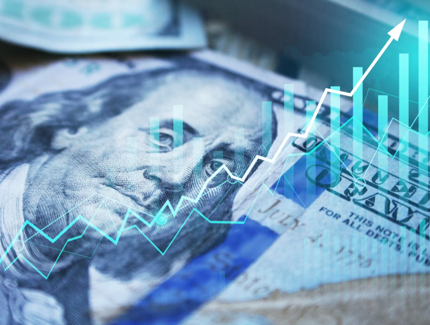Close-up of a US dollar bill overlaid with a growing financial graph, symbolizing rising inflation and economic trends